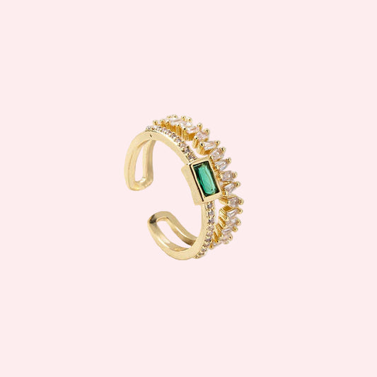 Anti-tarnish gold plated ring with a green gemstone on a light background